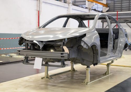 Car frame with unfinished assembly in the tester line of the automobile factory.